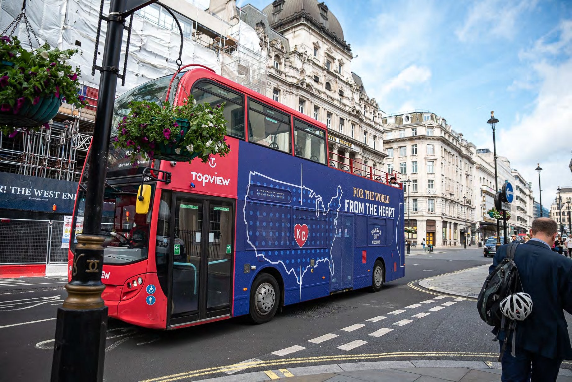 Open-top tourist bus rear advertising on a central London street