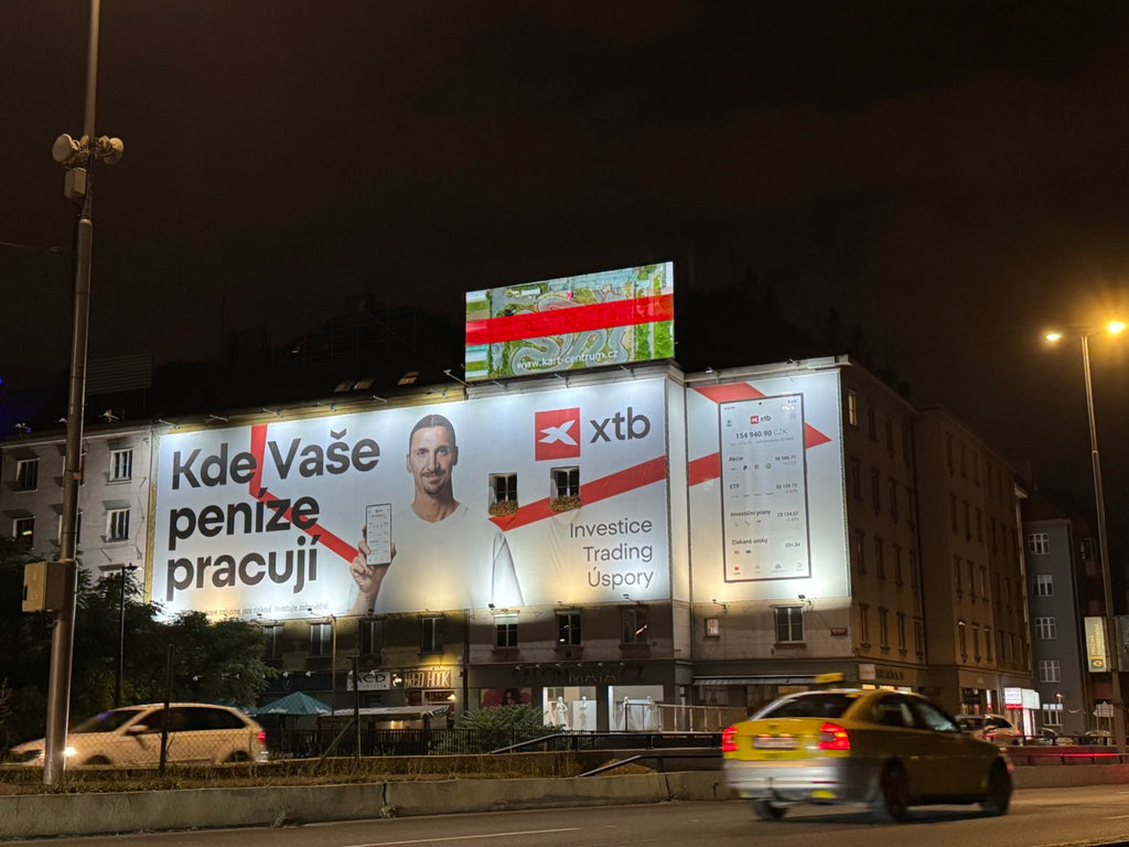 Digital billboard on the rooftop at Náměstí Hrdinů, Prague 4, seen from the road