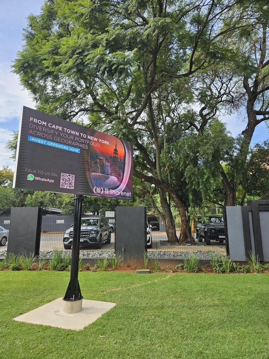 Free-standing digital screen running a live advertiser campaign at a premium South African padel venue