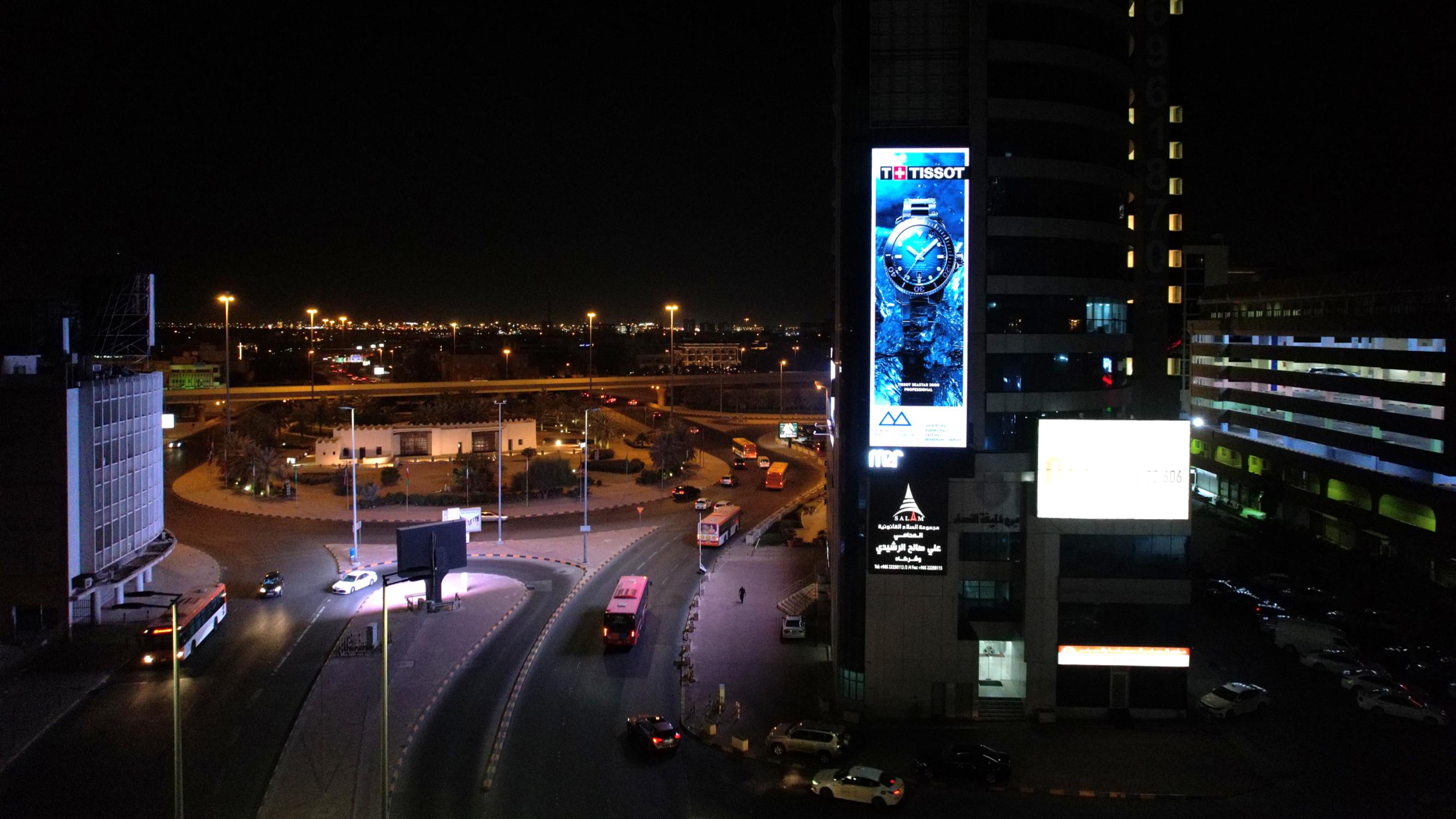 Vertical tower digital screen at night, Kuwait City
