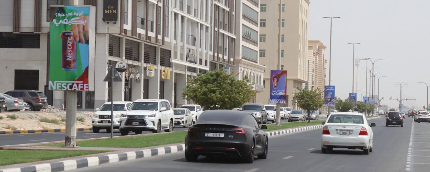 Backlit lamppost banner circuit on University City Street, Sharjah